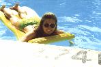 Close-up of Melanie floating in the pool